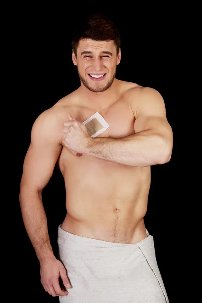 Handsome man waxing his chest. — Stock Photo, Image