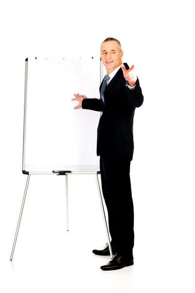 Male executive with marker pointing on someone — Stock Photo, Image