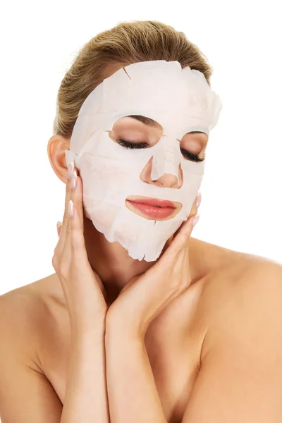 Young woman with facial mask — Stock Photo, Image