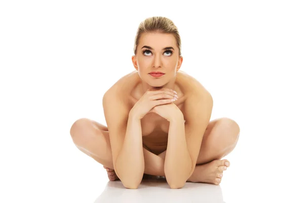 Young naked woman sitting on the floor — Stock Photo, Image