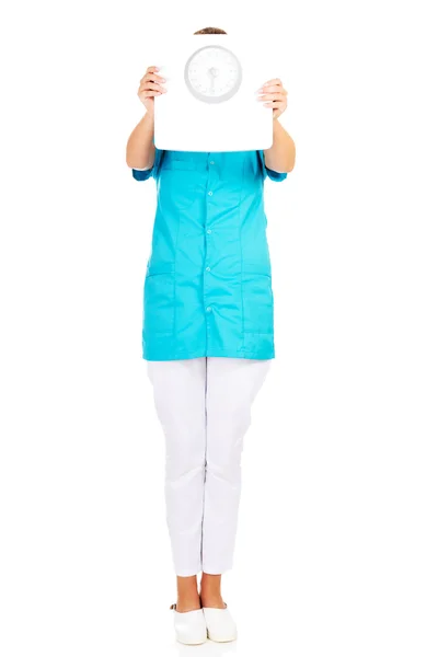 Young doctor or nurse holding weight — Stock Photo, Image