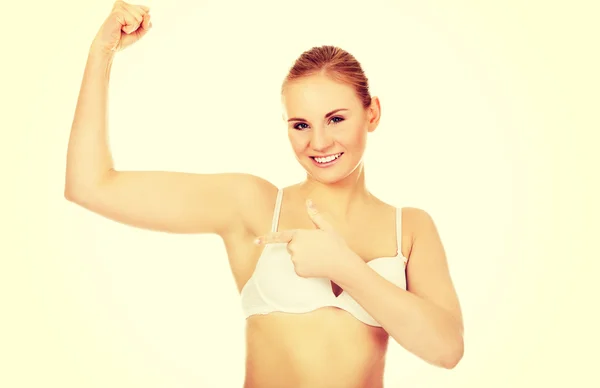 Athletic woman in white underwear shows her muscles — Stock Photo, Image