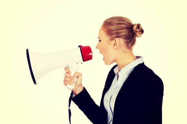 Young business woman screaming through megaphone — Stock Photo, Image