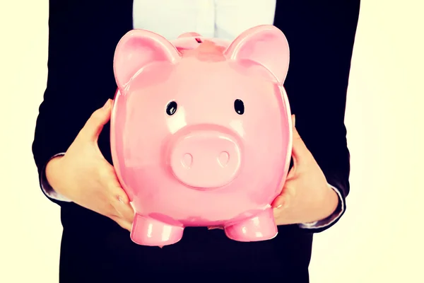 Joven mujer de negocios holiding piggybank — Foto de Stock