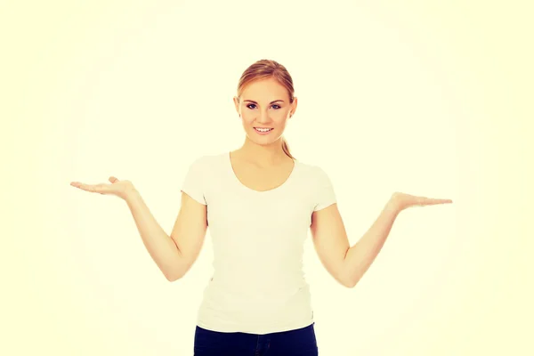 Young woman presenting something on open palms — Stock Photo, Image