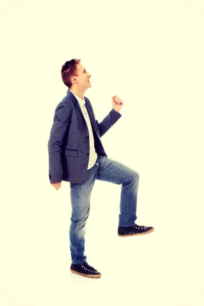 Side view of a businessman climbs the stairs — Stock Photo, Image