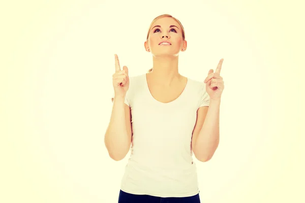 Happy young woman pointing up with both hands — Stock Photo, Image