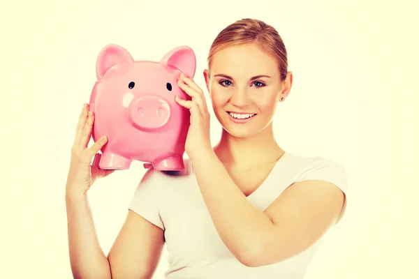 Happy young woman holding piggybank — Stock Photo, Image