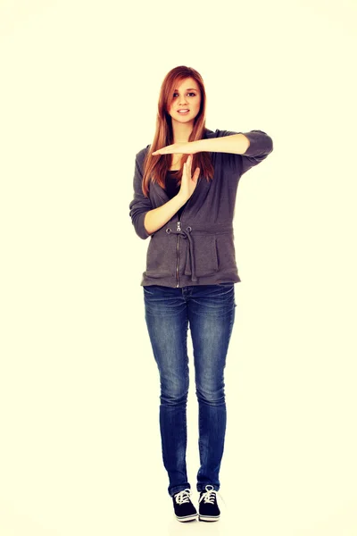 Teenage woman doing a break symbol — Stock Photo, Image