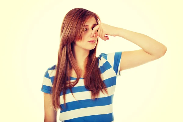 Teenage woman holding her nose because of a bad smell — Stock Photo, Image