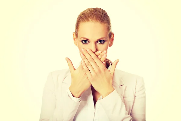 Young business woman covering her mouth with two hands — Stock Photo, Image