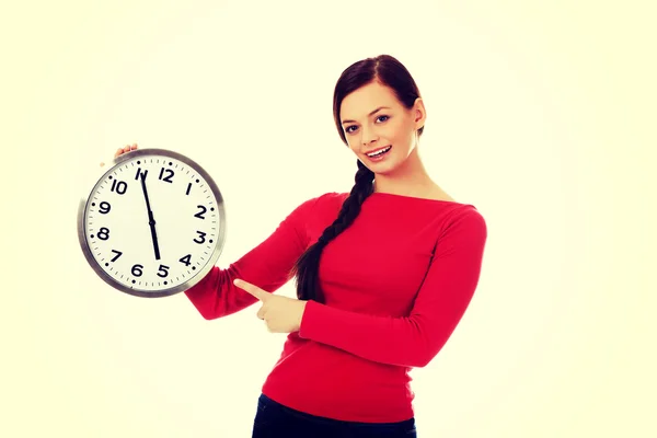 Happy young woman holding clock — Stock Photo, Image