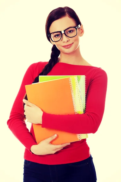 Jovem estudante sorrindo mulher segurando livros — Fotografia de Stock