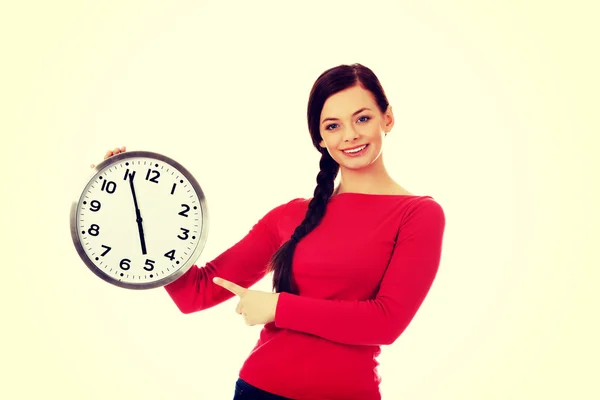 Happy young woman holding clock — Stock Photo, Image