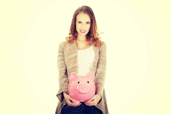 Casual vrouw met piggy-bank. — Stockfoto