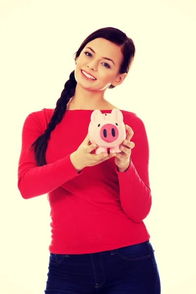 Happy young student woman holding piggybank — Stock Photo, Image