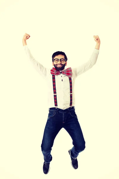 Old fashioned man wearing suspenders jumping. — Stock Photo, Image