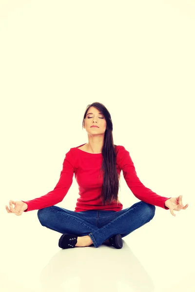 Sporty woman practicing yoga lotus pose. — Stock Photo, Image