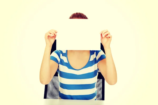 Teenage woman covering face with paper card — Stock Photo, Image