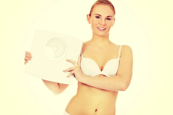 Slim woman holding a weight scales — Stock Photo, Image