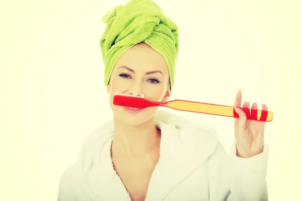 Beautiful woman with oversized toothbrush. — Stock Photo, Image