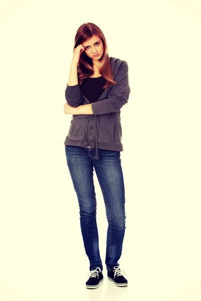 Worried teenage woman with folded arms — Stock Photo, Image