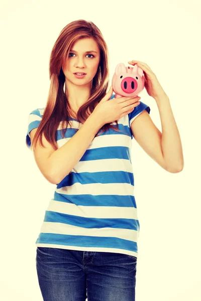 Happy teenage woman holding piggybank — Stock Photo, Image