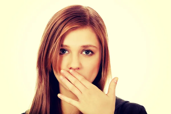 Teenage woman covering mouth with hand — Stock Photo, Image