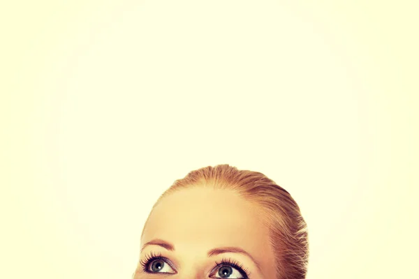 Beautiful female eyes looking up for copyspace or something — Stock Photo, Image