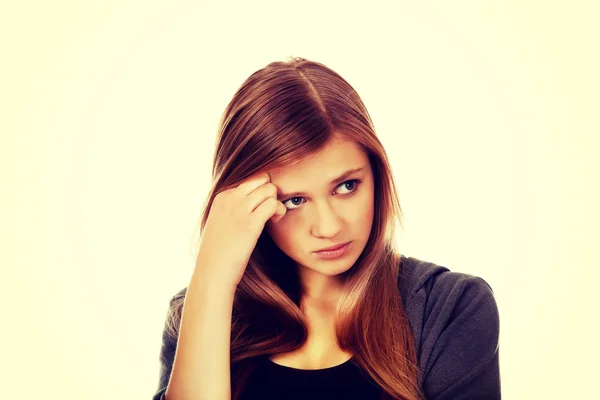 Worried teenage woman with folded arms — Stock Photo, Image