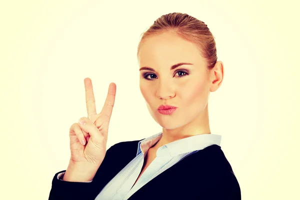 Happy business woman showing victory sign — Stock Photo, Image