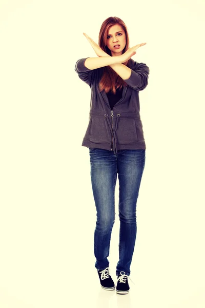 Teenage woman making stop sign with crossed hands — Stock Photo, Image