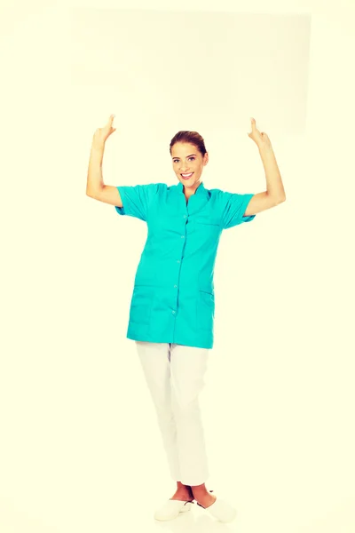 Giovane medico o infermiera con banner vuoto — Foto Stock