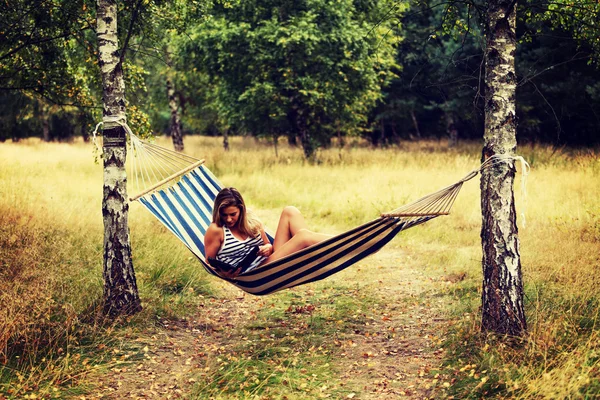 Young woman with tablet on the hammock — Stock Photo, Image