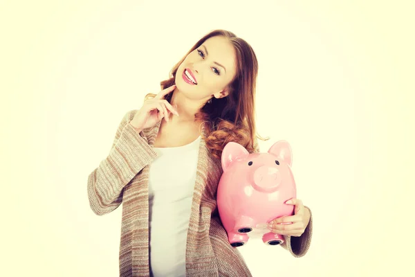 Casual woman holding piggy-bank. — Stock Photo, Image