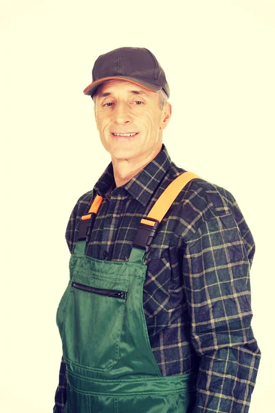 Mature gardener standing in uniform — Stock Photo, Image