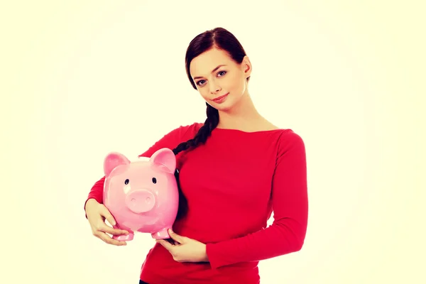 Happy young student woman holding piggybank — Stock Photo, Image