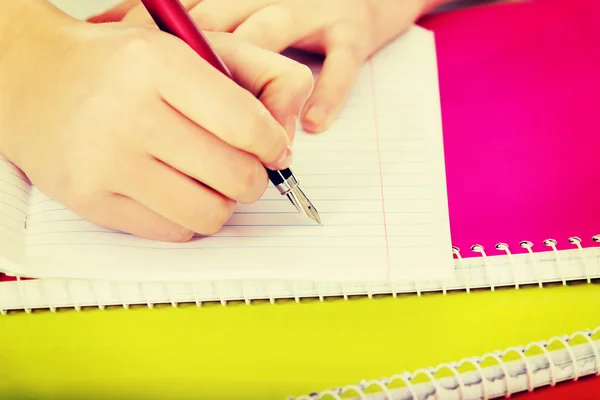 Teenage woman hand doing a homework — Stock Photo, Image