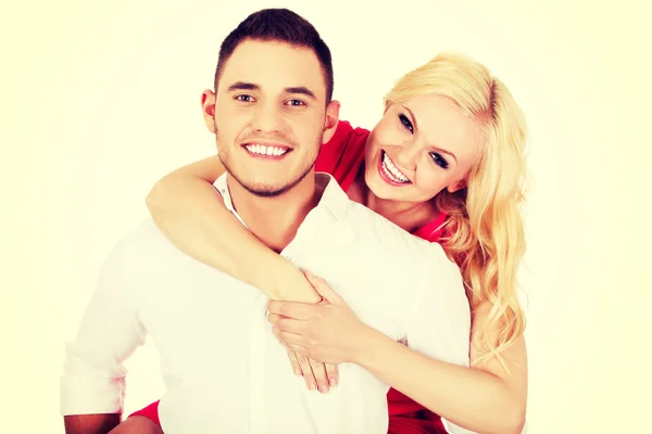 Young man giving piggyback to his girlfriend — Stock Photo, Image