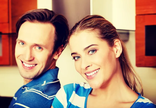 Lovely young couple standing in kitchen — Stock Photo, Image