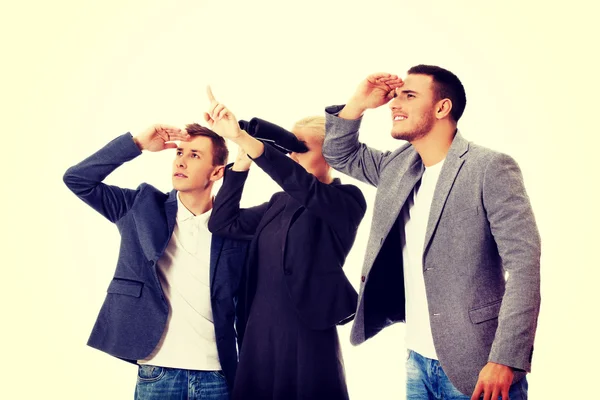 Business team looking into one direction-woman using binoculars — Stock Photo, Image