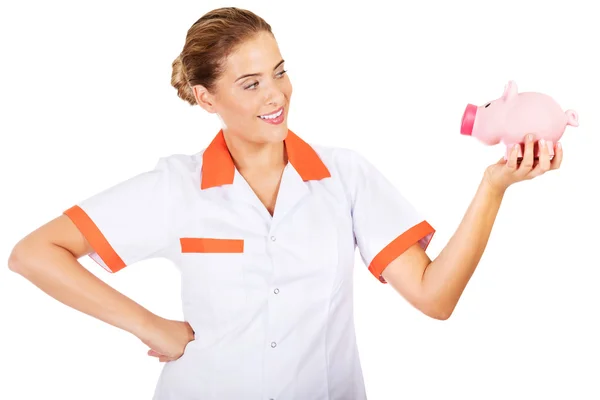 Молода красива жінка-лікар або медсестра тримає скарбничку — стокове фото