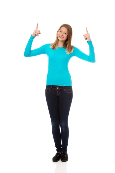 Young woman pointing up with both hands — Stock Photo, Image