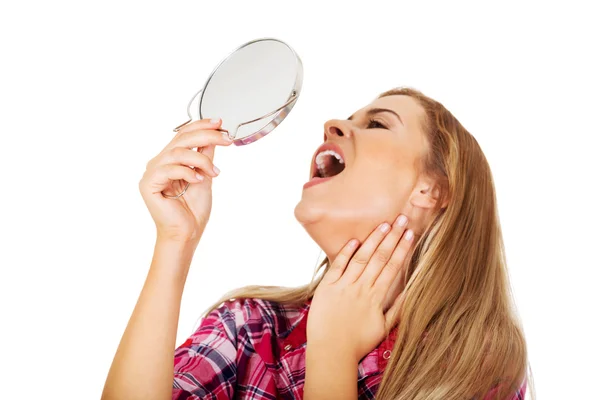 Young smiling woman holding a mirror — Stock Photo, Image