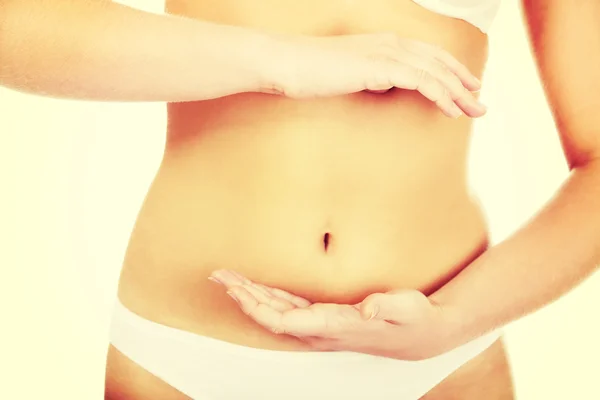 Slim woman belly with hand on it — Stock Photo, Image