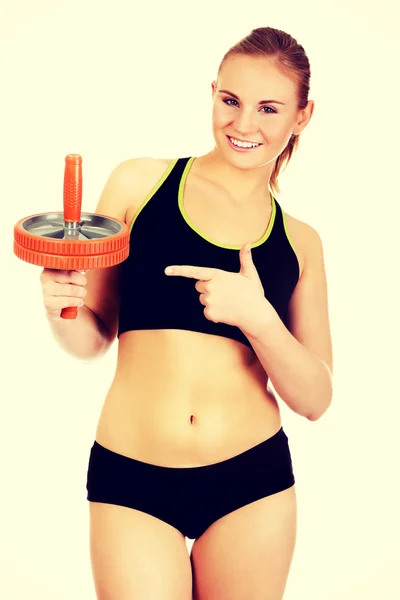 Young and sporty woman holding sport wheel — Stock Photo, Image