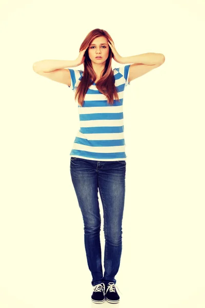 Teenage woman with headache holding her hand to the head — Stock Photo, Image