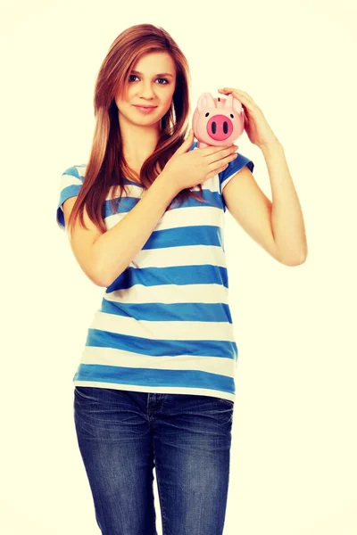 Happy teenage woman holding piggybank — Stock Photo, Image