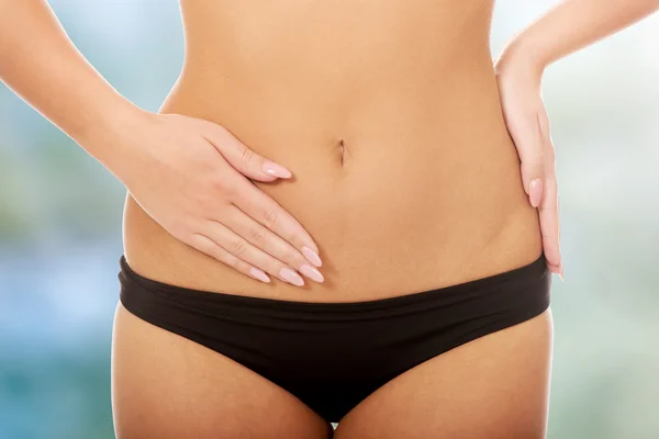 Woman touching her slim belly. — Stock Photo, Image