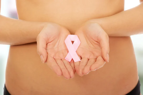 Female hands holding pink ribbon. — Stock Photo, Image